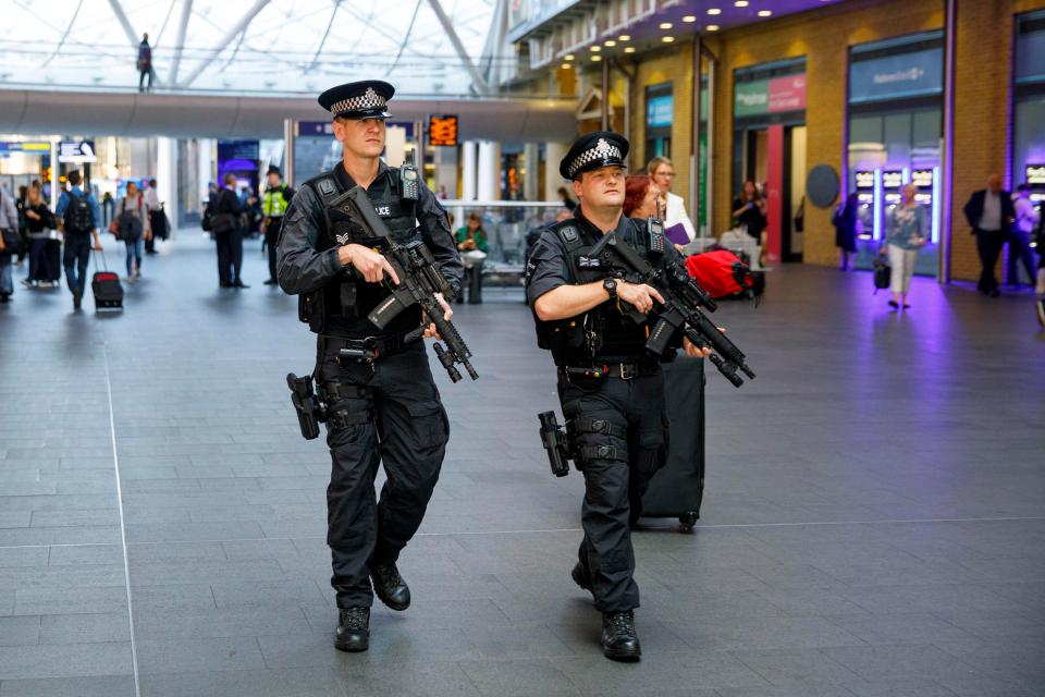  Armed police officers patrol at King's Cross station in London this morning