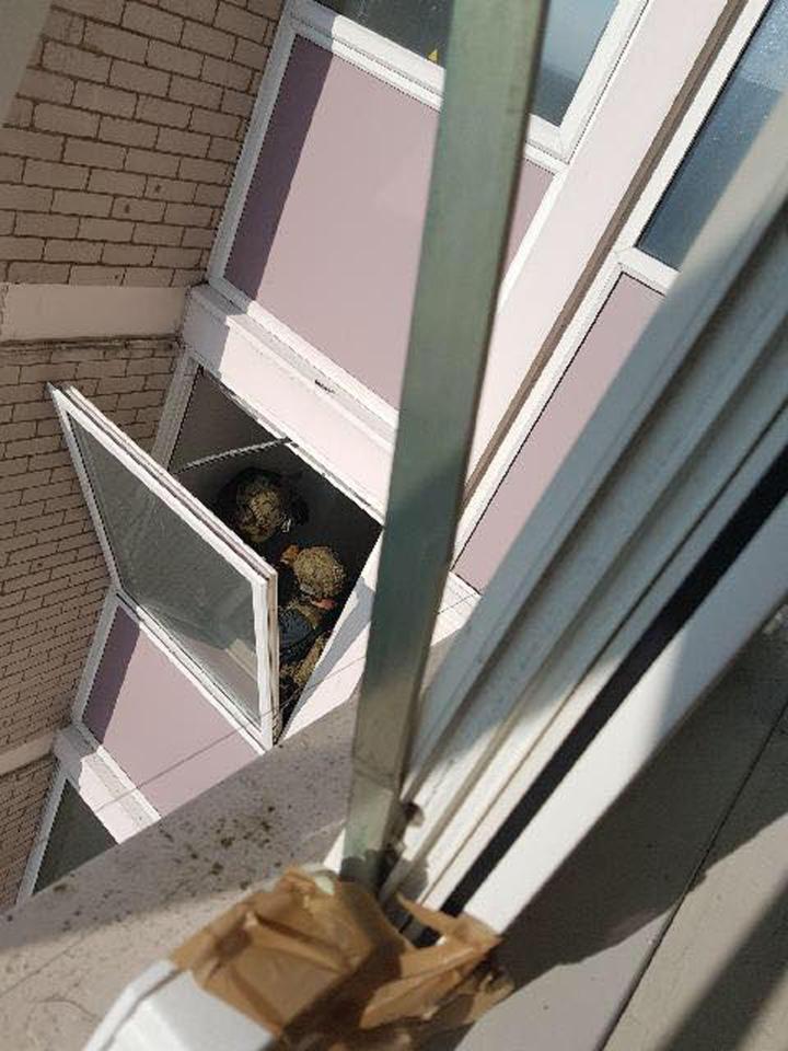 Armed cops were spotted searching through the high-rise