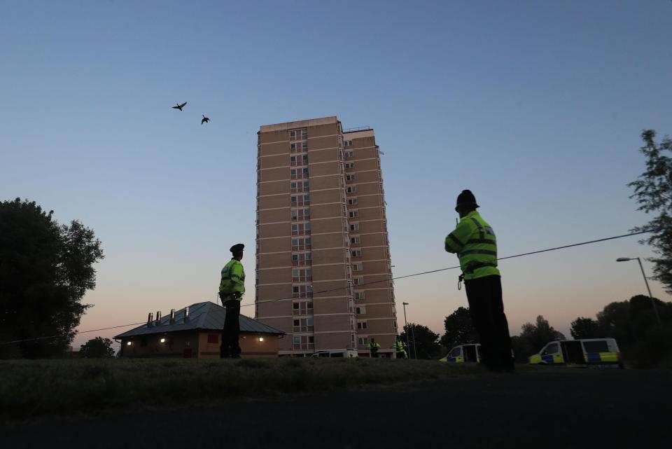 Police outside a block of flats they raided in Blackley, north Manchester
