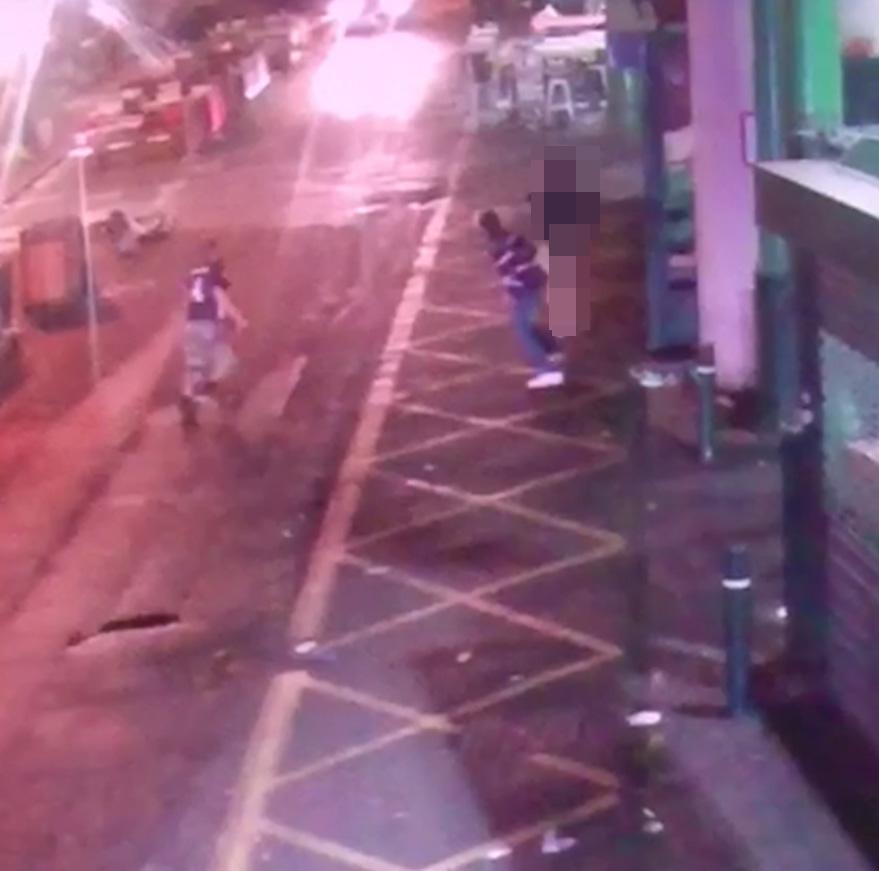 Another one of the terrorists approaches the scene and races to attack the victim