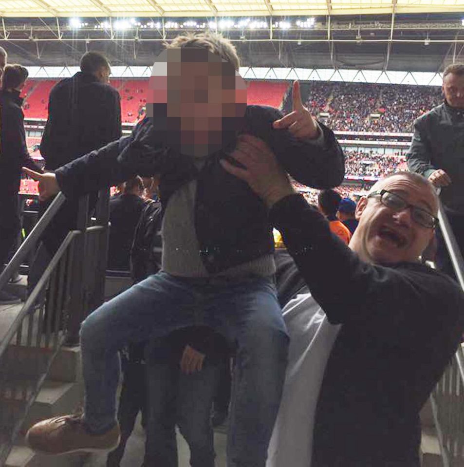  Millwall diehard Roy with young supporter at a football match at Wembley