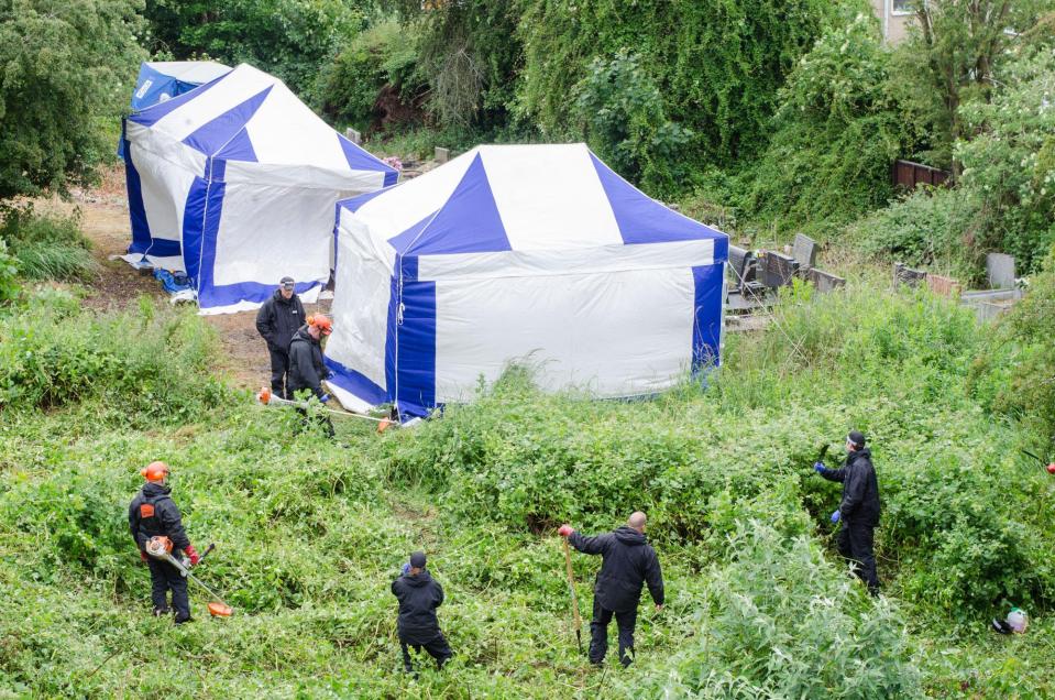  Forensic tents were erected in the cemetery as police combed through the grassland