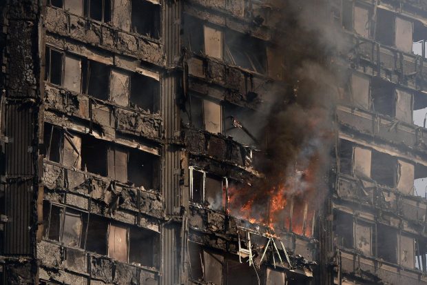 Debris falls from the 24-storey residential tower block as more than 200 firefighters continue to tackle the blaze