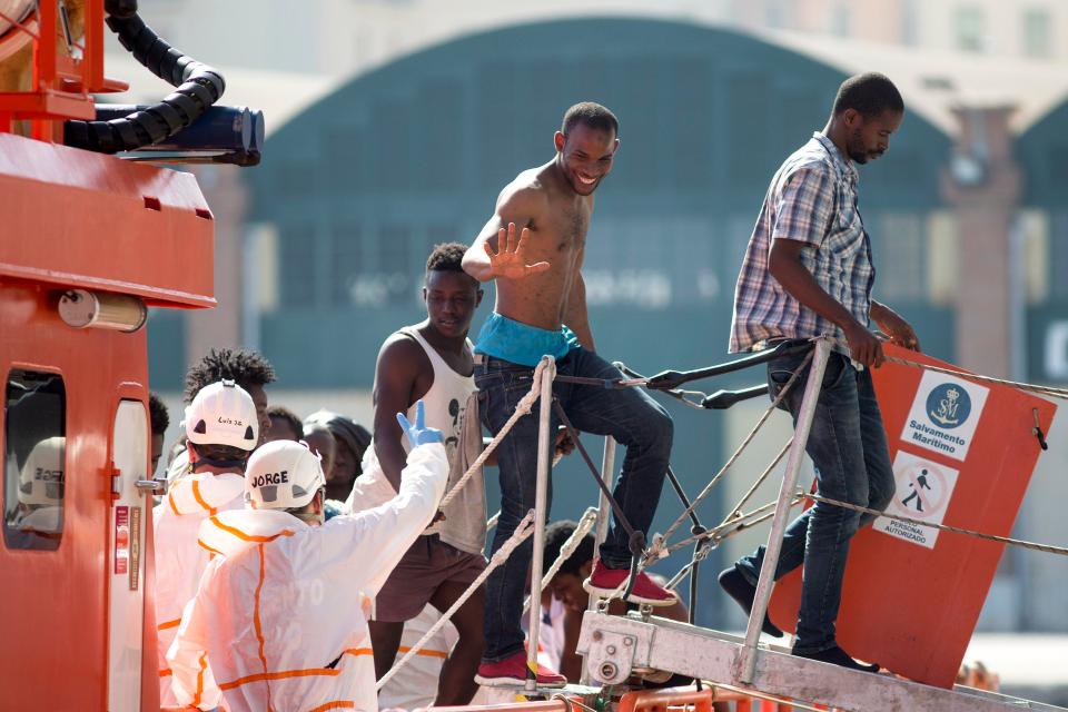 A migrant waves to a Spanish rescuer at Malaga. Last year 6,726 migrants were rescued as they tried to enter Spain by sea