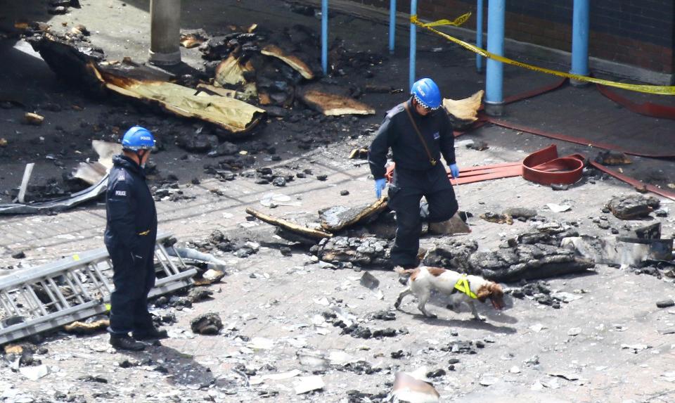 Police are using sniffer dogs to search through the carnage that the fire wrought on the residents of Grenfell Tower
