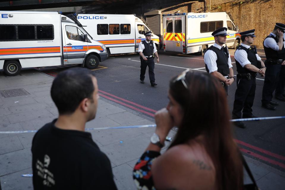 Shocked onlookers near the police cordon this morning