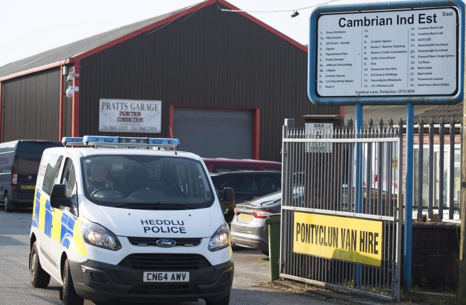  A police van leaves the site of Pontyclun Van Hire at the East Side Cambrian Industrial Estate
