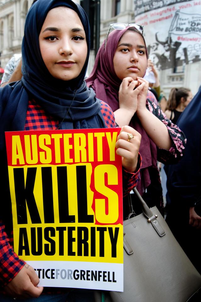  Protesters hold signs demanding justice for the Grenfell Tower victims