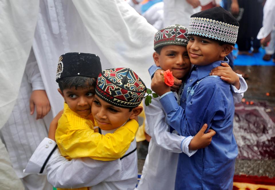 Children greet each other after offering Eid al-Fitr prayers which mark the end of Ramadan in Mumbai, India