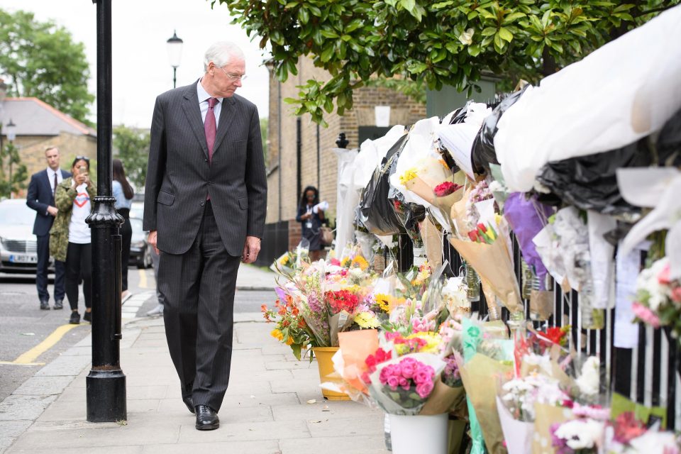  The judge looks at floral tributes as he leaves the Parish of St Clement church after meeting local residents today