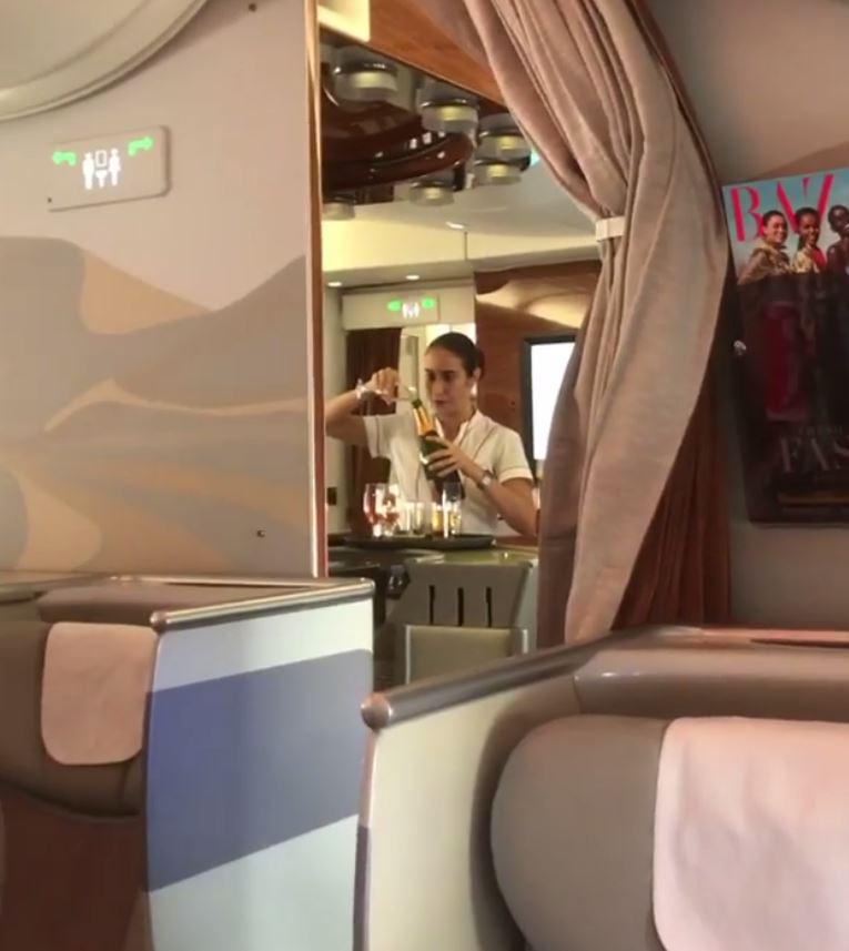 A flight attendant in Emirates Business Class has been caught pouring a glass of Champagne back into the bottle