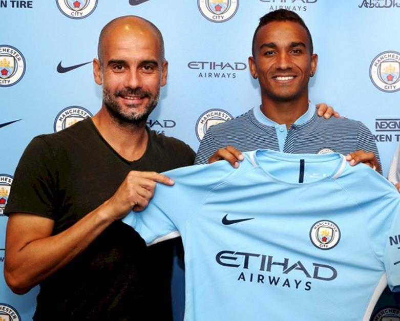 Pep Guardiola and Danilo hold a Manchester City shirt together after the Brazilian signed for the Premier League club