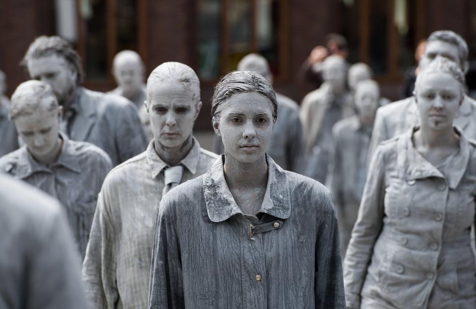 The left-wing activists covered themselves in grey clay