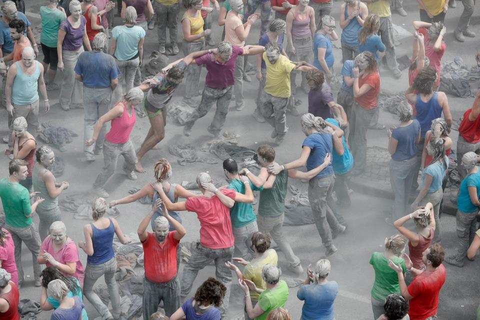 They revealed brightly coloured clothes or their naked bodies under the grey clay