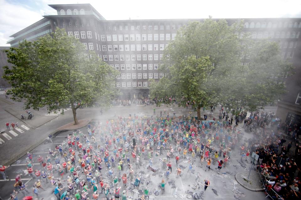 Once they assembled in a central square, the activists ripped off their outer grey coverings