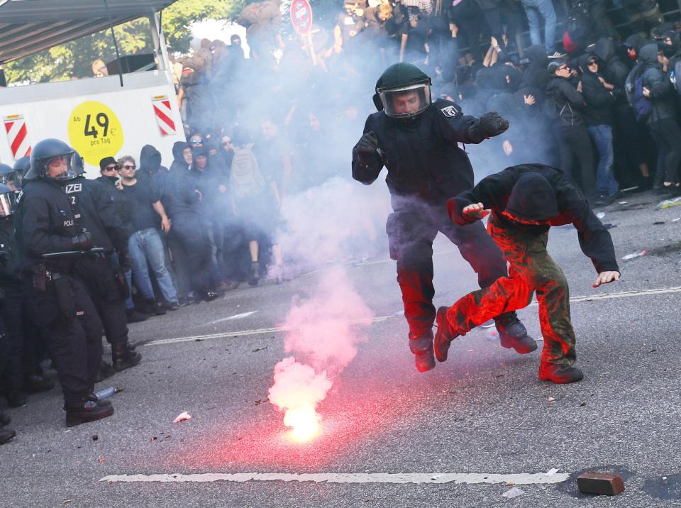 One protester sprinted away after setting off a flare