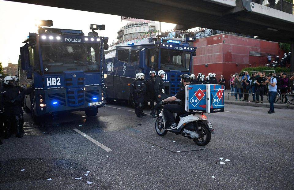  The delivery man was pictured squaring up to riot police