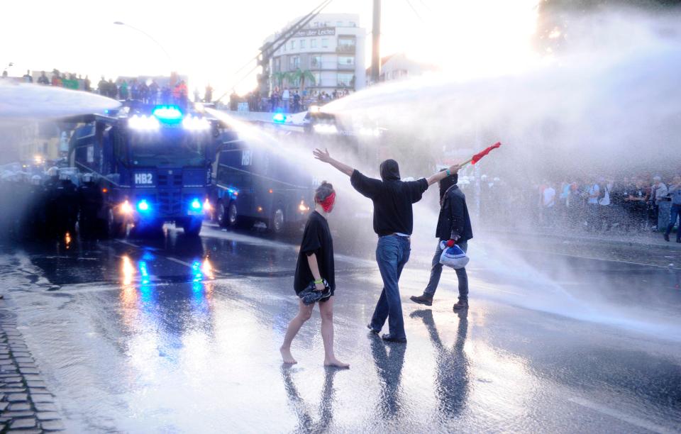 Marchers were seen waving flags as German police unleashed the water cannons