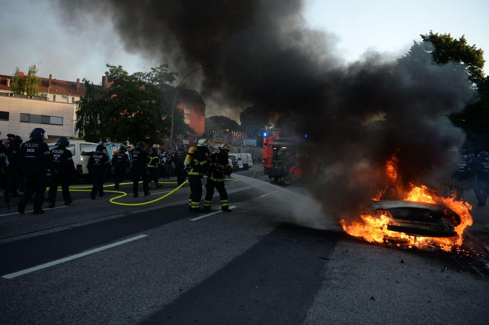 Firefighters were seen putting out a blaze after the car was set alight