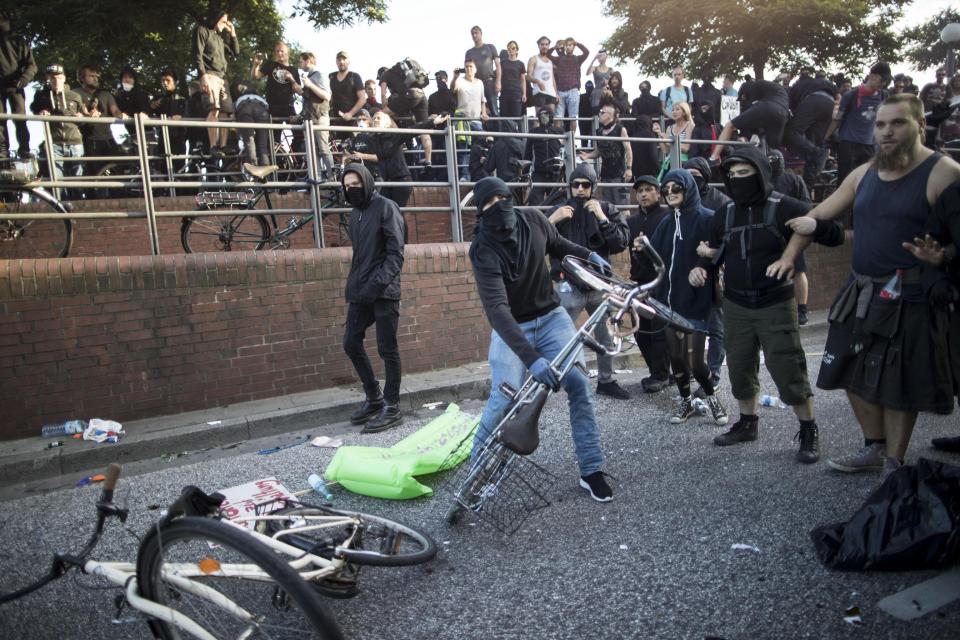  A group of protesters with their faces covered were pictures with bikes