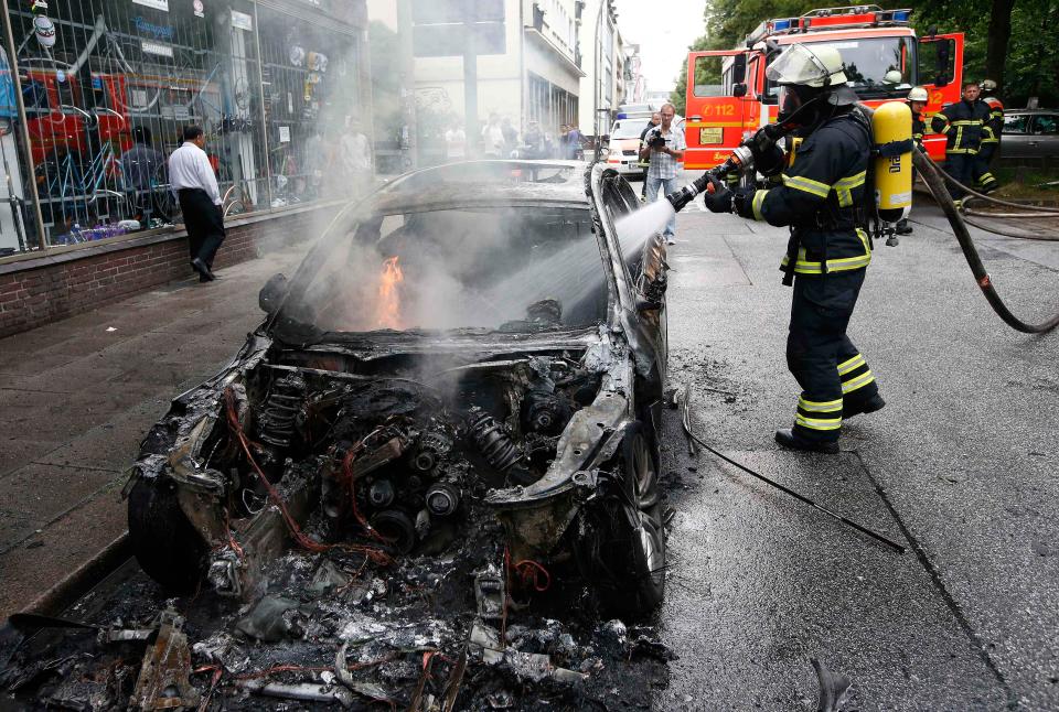  A firefighter works at the scene where a number of cars were burnt out in Hamburg