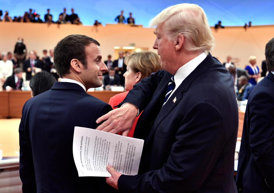  Trump accidentally showed the world his speech while patting President Macron on the back