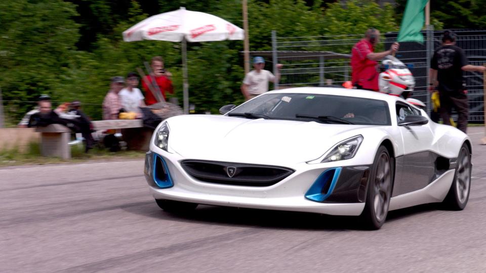  A white sports car whizzes along a track