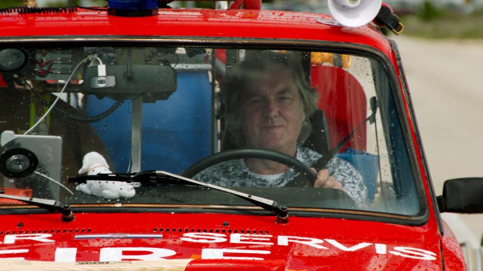  May looked slightly less thrilled than the other two in a heavily customised red car