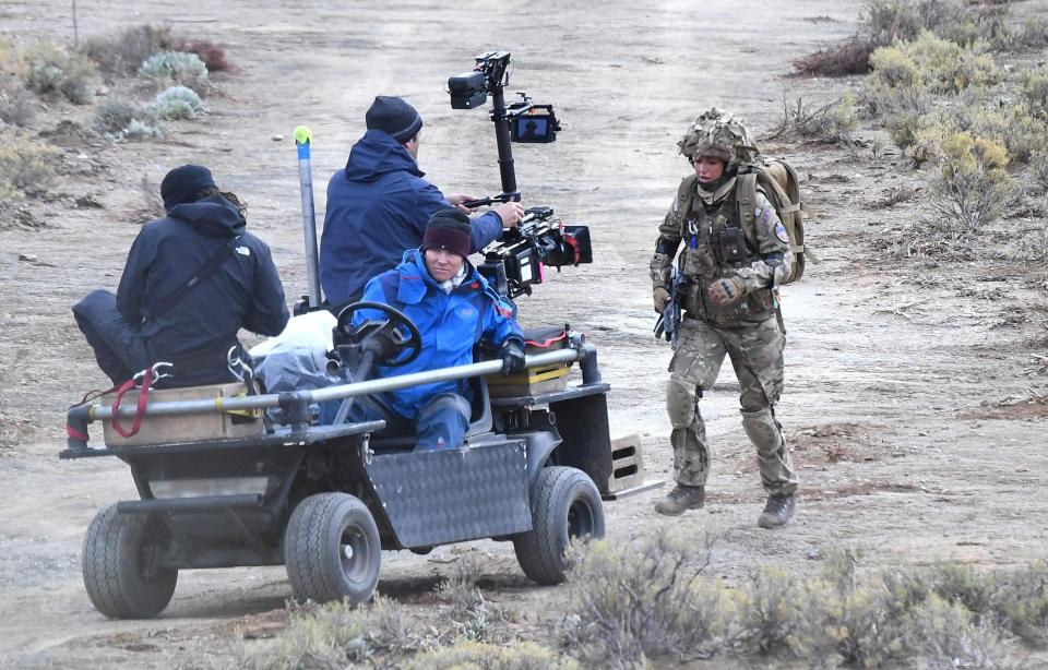  A camera crew tracks the star as she runs through the South African scrub