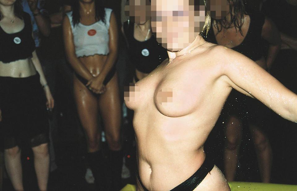 A woman poses for the camera during a bar game at a Wet And Wild night in 2001 