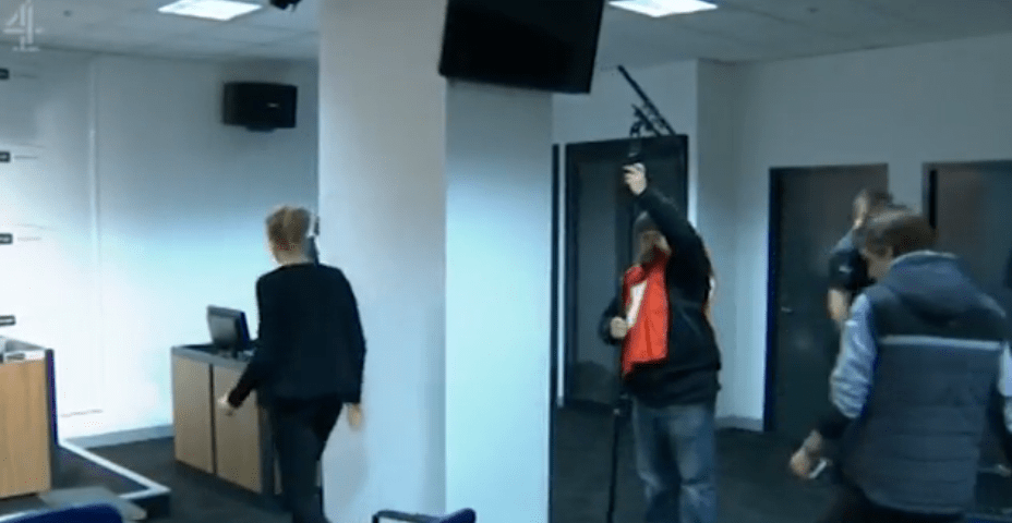  A view of a strange room showing the setting up of a press conference cut through the Sunday Lunch episode
