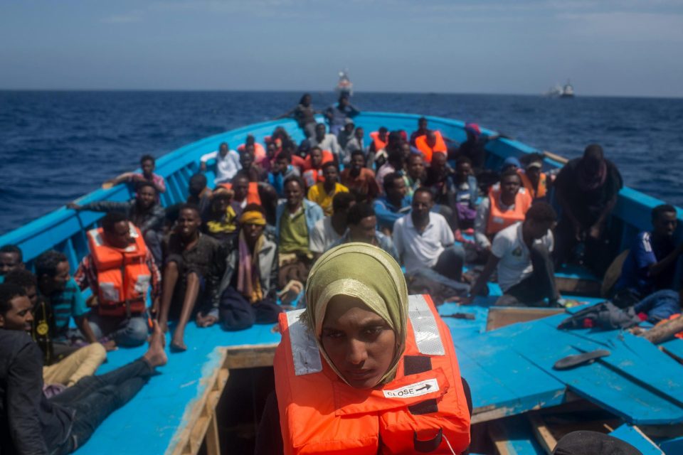  North African refugees and migrants, on a wooden boat off the Italian island of Lampedusa, wait to be rescued in May