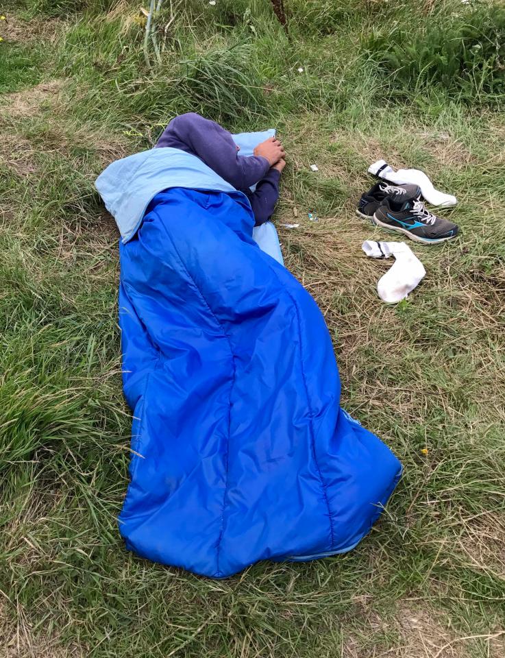  Migrant sleeps next to his Mizuno trainers