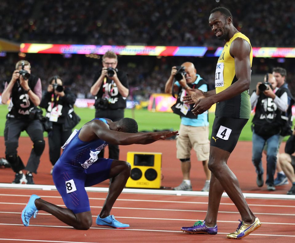 Despite clinching gold Justin Gatlin bows at the feet of Usain Bolt