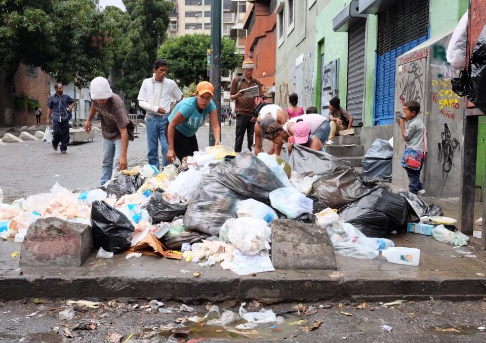  Venezuelan people rummage through litter looking for food