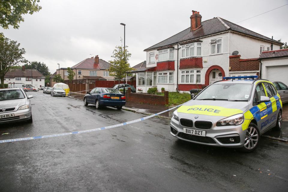  Police tape and cop cars cordoned off the street where the teenage boy was stabbed