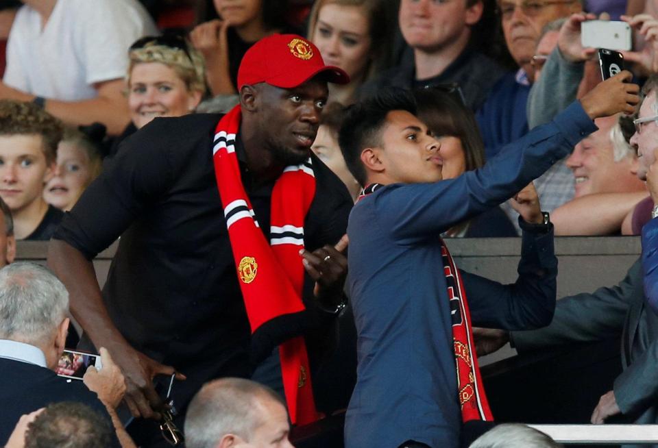 Usain Bolt poses for a selfie with a fan at Old Trafford