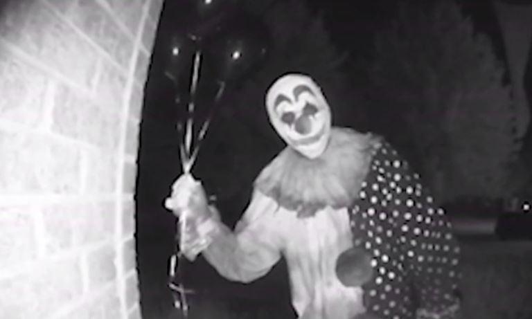  It approaches the front door while clutching some balloons and peers in