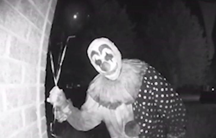  The creepy clown peers into the camera on the front of the family home in the US