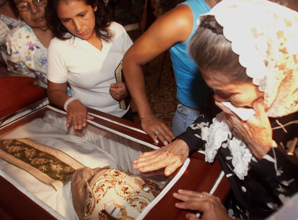  In March 2002, weeping mourners pay tribute to the slain Colombian Roman Catholic archbishop who was a fierce critic of leftist guerrillas and drug traffickers