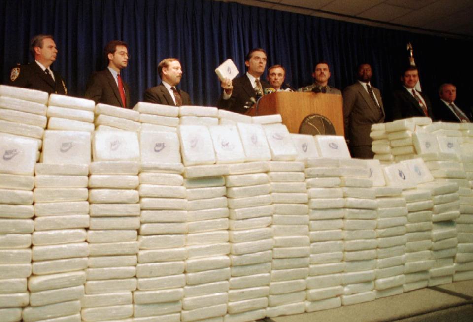 Law enforcement officials stand behind some 1,500 kilos of cocaine with a street value of $250 million at a press conference in New York