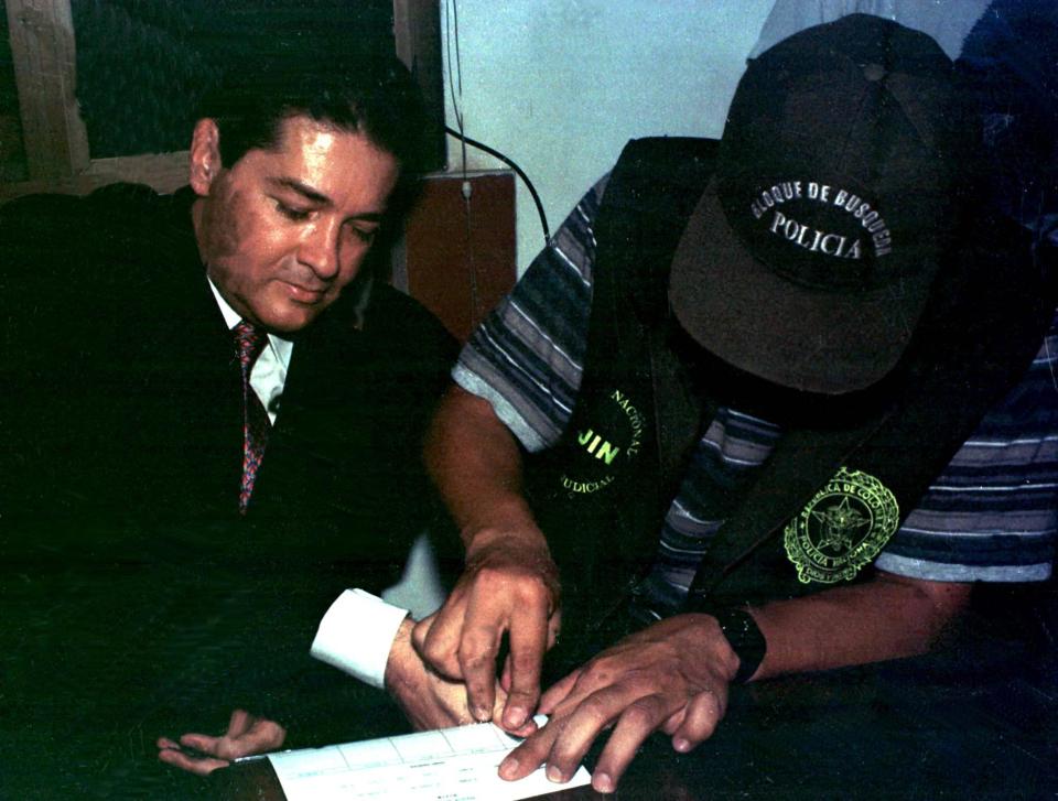  Colombian drug lord Helmer Herrera has his fingerprints taken after he surrendered to police
