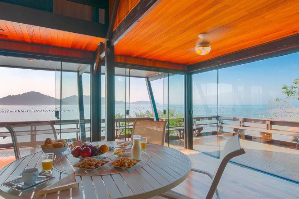  Inside, it's a stunning beach house with panoramic sea views and modern furniture