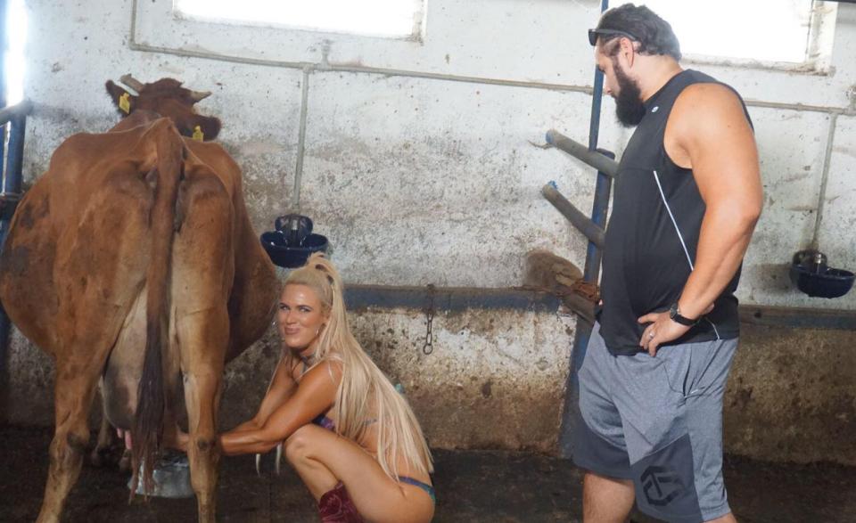  The WWE star even got her own hands dirty by digging in and milking the cows