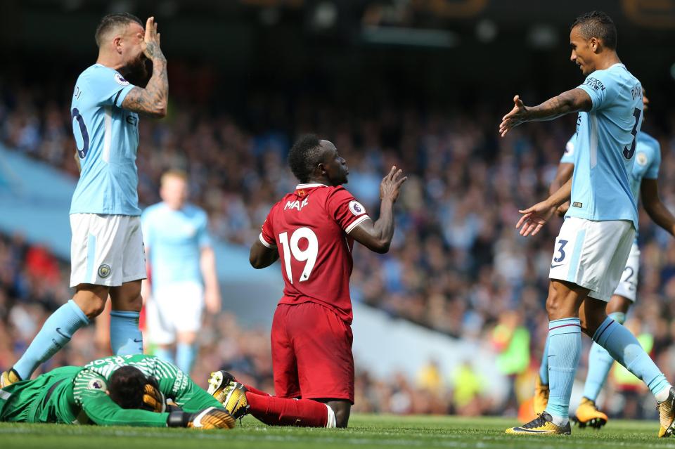  Sadio Mane sees a straight red card from the referee as Ederson lays on the floor injured