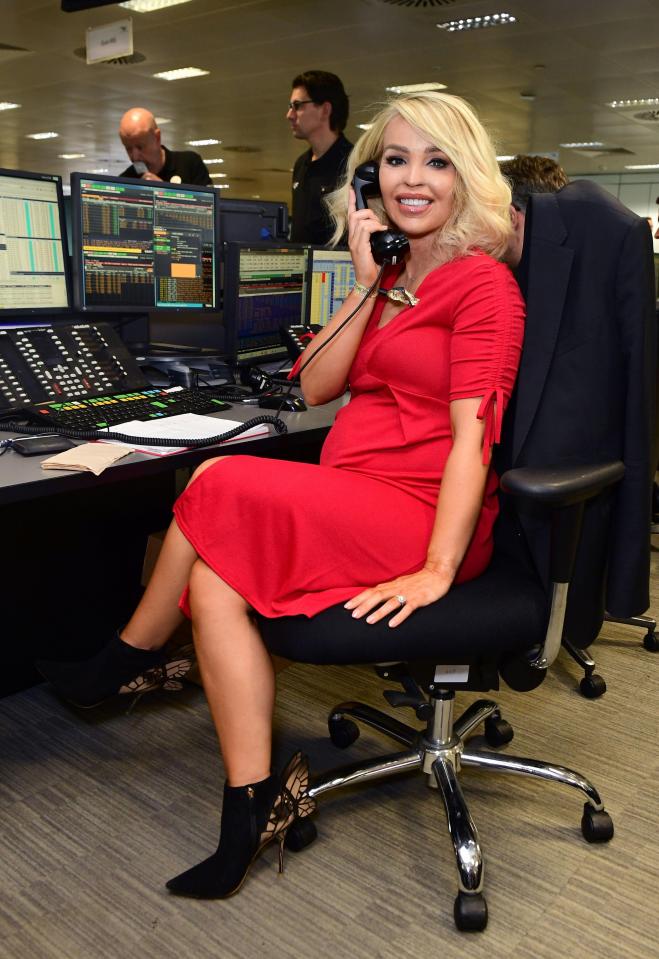  Katie took a seat at a stockbroker's desk while making her calls