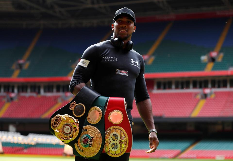 Joshua parades his trio of belts at Cardiffs Principality Stadium
