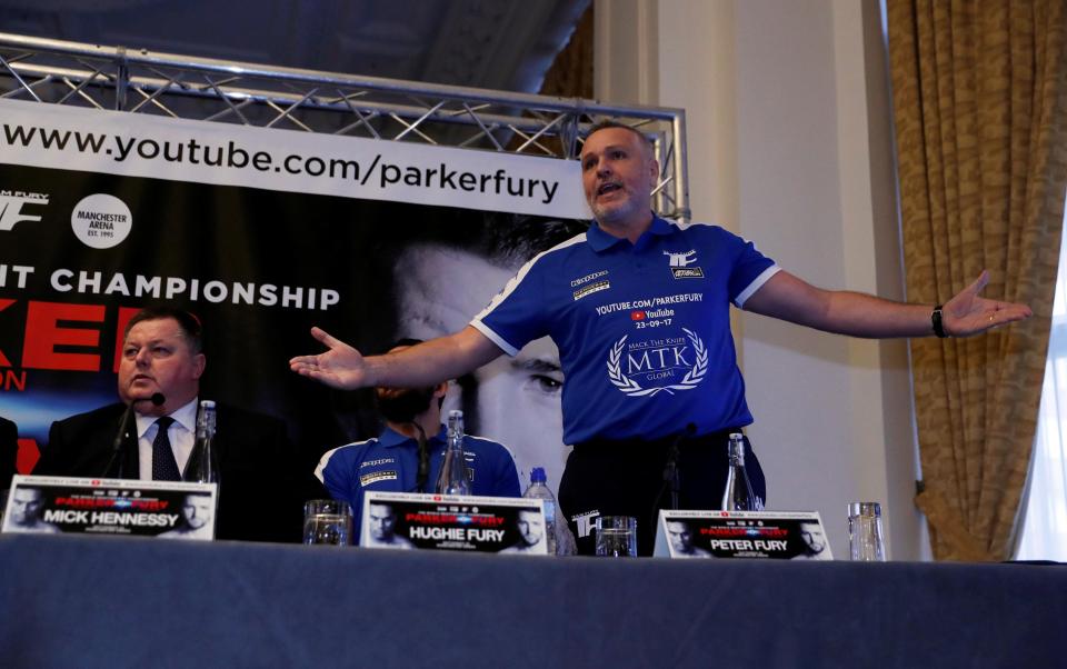 Hughie Fury laughs as his father shouts at promoter David higgins