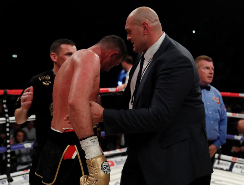 Hughie Fury is consoled by Tyson Fury after a battling to defeat
