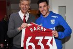 Arsenal manager Arsene Wenger presents Gareth Barry with a special shirt to mark the occasion